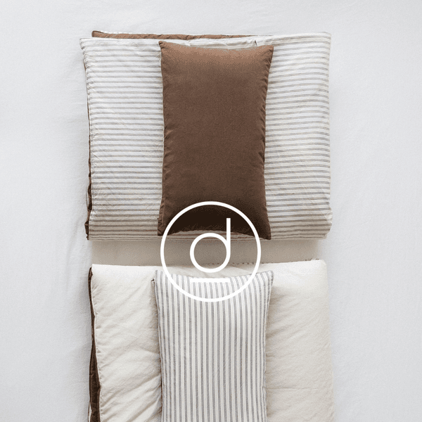 A collection of colorful soft baby bibs arranged in a circular pattern