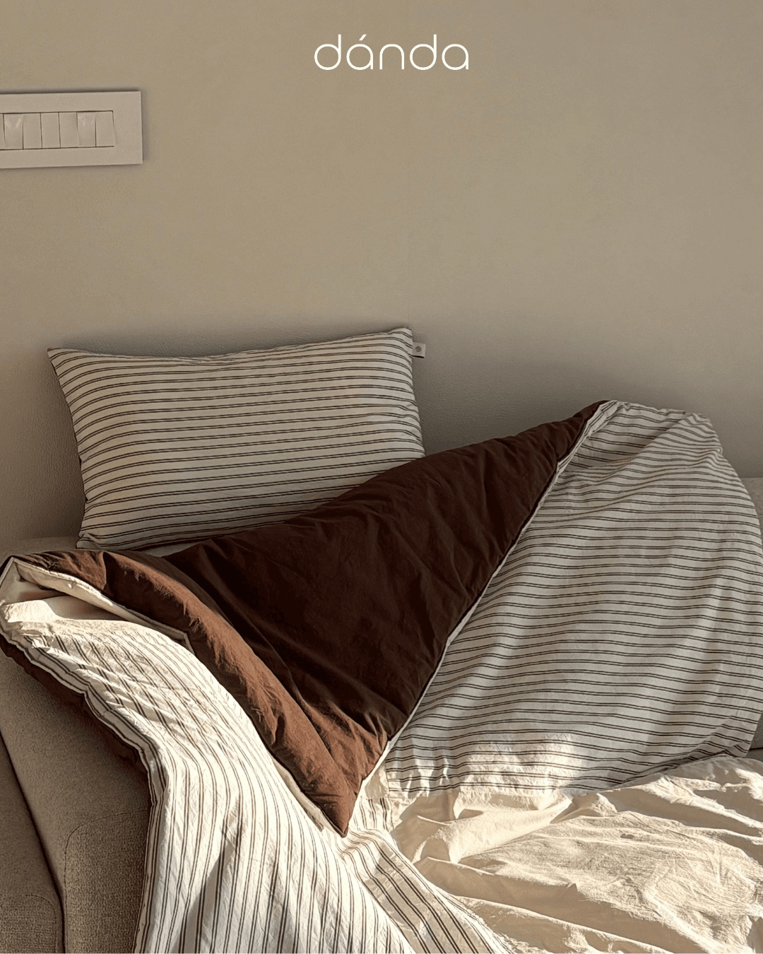 Warmly lit living space with neutral textured linens